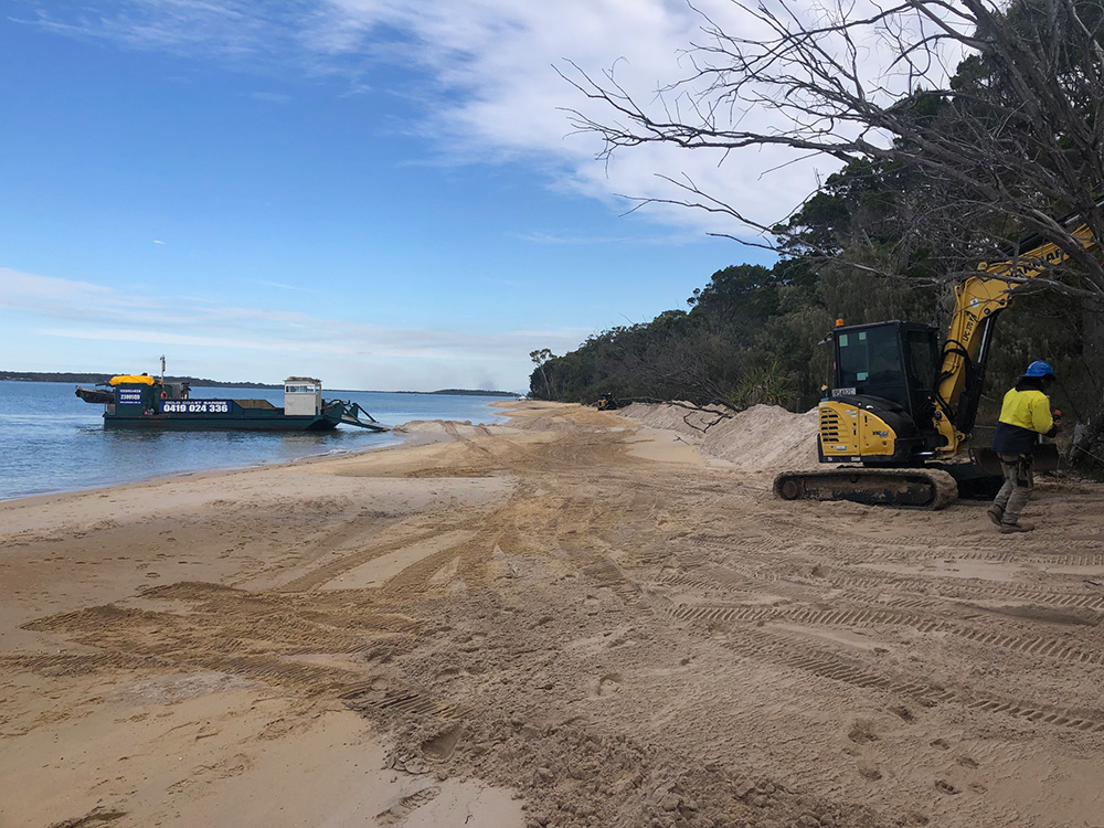Council barge and back hoe contractors working on Morwong Beach on the sand replenishment project, June 2023